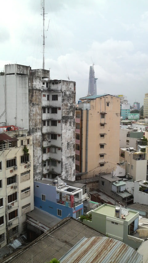 I love the little two-toned blue building at the bottom of this photo, with the balcony and water-heater on the roof. This is the modern Vietnamese street style!