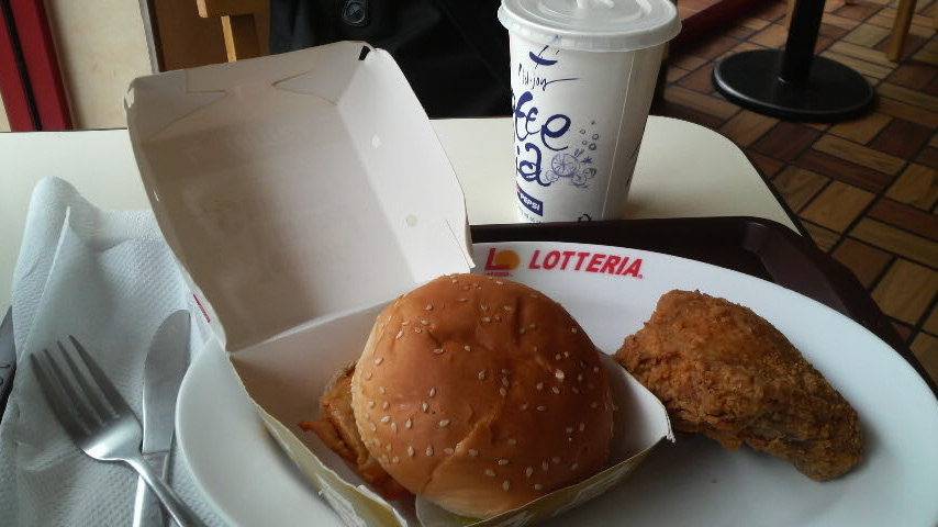 Chicken burger and a piece of chicken and a waxed paper cup of Coke!