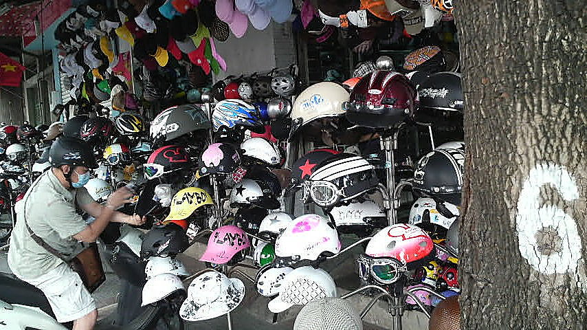 Helmets, goggles and hats for sale in a streetside Saigon shop