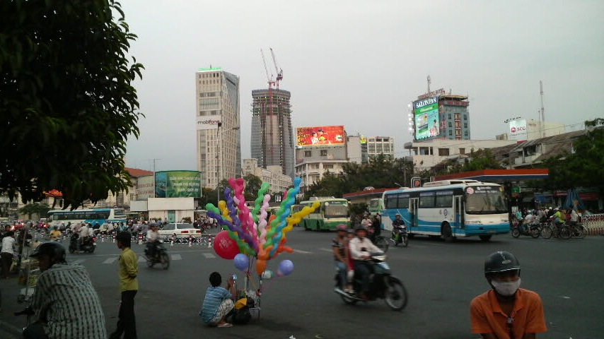 Street scene including balloon vendor near Ben Thanh Market