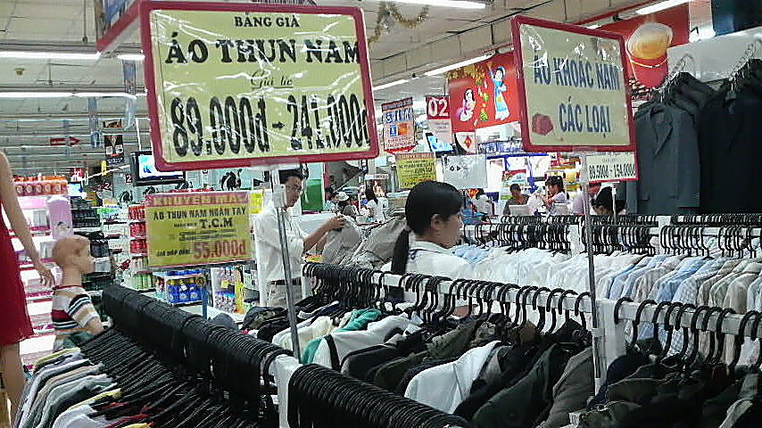 Clothes and in the background suits for sale in a Saigon supermarket