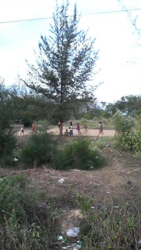 Local teenagers play volleyball on a vacant beachside lot: Mui Ne, Vietnam